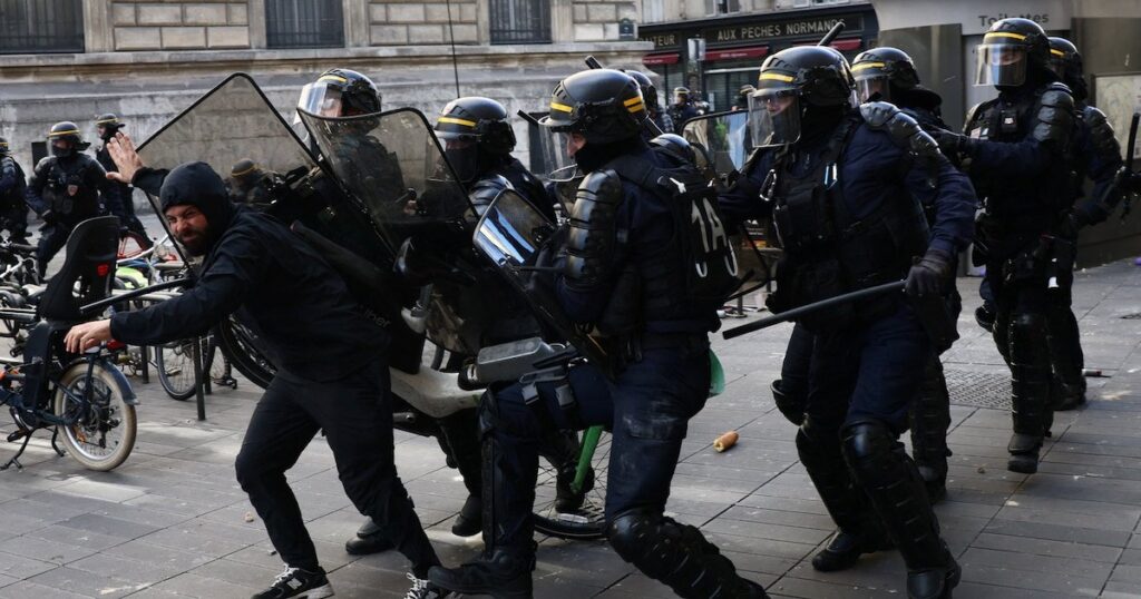 Agentes antidisturbios forcejean con un manifestante durante las protestas del sábado 17 de octubre en Francia